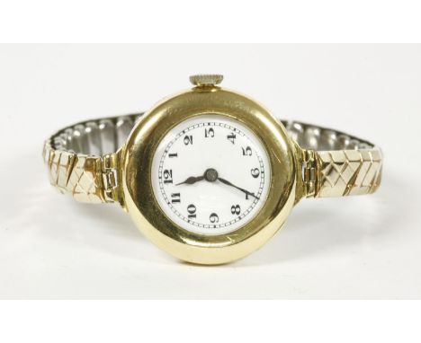A ladies 18ct gold mechanical watch, with white enamel dial and Arabic numerals, with later expanding bracelet26.05g