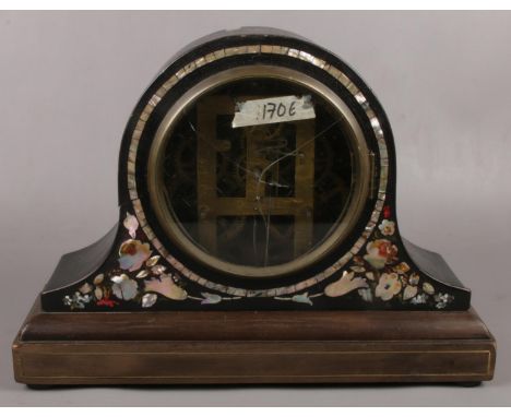 A dome top painted mantel clock with mother of pearl inlay and open movement.  