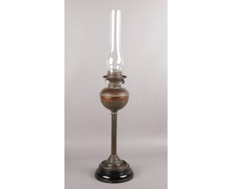 A brass oil lamp with glass shade  