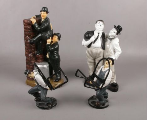 A group of Laurel &amp; Hardy ceramic figures, climbing over a wall, book holders examples  