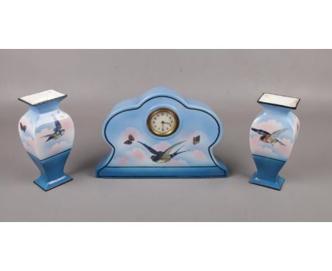 A c1920 Staffordshire ceramic clock garniture in blue, printed with birds.  