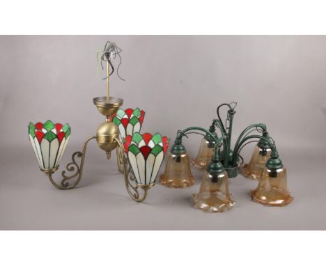 Two ceiling light fittings, a brass three arm fitting with tiffany style shades, a metal five arm fitting with glass shades  