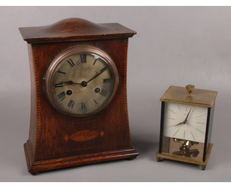 An inlaid oak mantel clock movement stamped PHS along with a German Shcats glass torsion clock.  No key for torsion clock. No