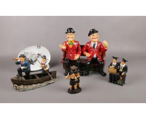 A group of Laurel &amp; Hardy ceramic figures, in a rowing boat, sat on a bench, sat on suitcase examples  
