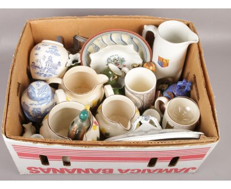 A box of miscellaneous to include graduated ceramic jugs, Wedgwood tankards, horse brasses, etc.  