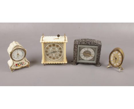 Four plastic and metal alarm clocks to include, "Estyma" cream clock decorated with multi coloured flowers, and "Eurastyle" d