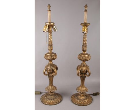 A pair of large gilt metal table lamps. (90cm tall)  No damage. Light pull not working on one lamp. Would need to be tested b