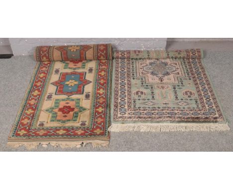 A wool green ground rug (149cm x 95m) along with a multi coloured carpet runner. (290cm x 60cm)  