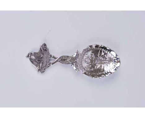 A 19th century Dutch silver caddy spoon, the frill and bead edged bowl decorated with figural harbour scene featuring fisherm