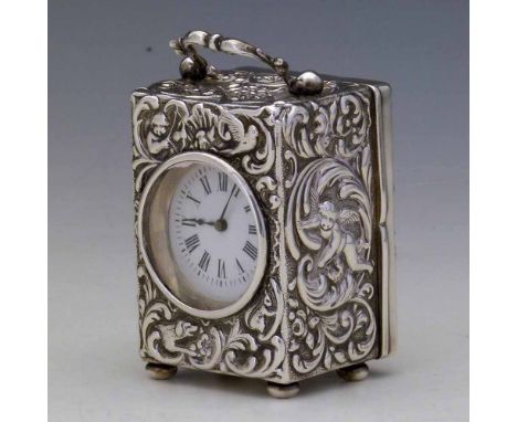 Silver cased miniature carriage clock, Dimier Bros, London 1896, embossed with cherubs and foliage, white enamel dial, French
