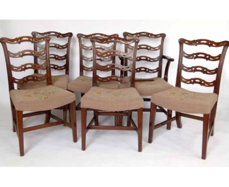 Set of six mahogany wavy ladder back dining chairs, including a carver with stuffed over seats.