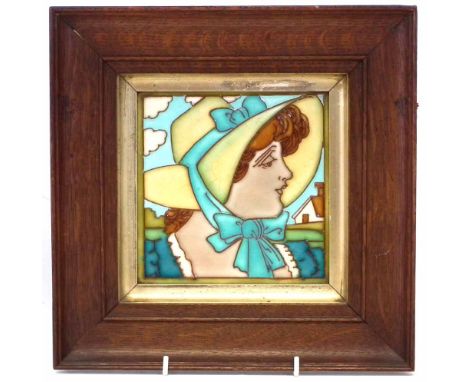Frederick Rhead designed tile, tubed lined by Charlotte or Dollie with a portrait of a lady wearing a bonnet, with period oak