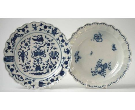 Two Worcester plates circa 1770, one painted with Hundred Antiques pattern, the other printed with fruit sprays, crescent mar