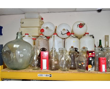 A LARGE COLLECTION OF WINE MAKING EQUIPMENT, to include over 30 clear and brown glass demijohns, a large vintage carboy heigh