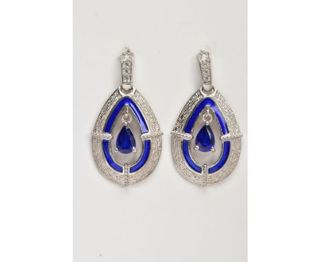 A PAIR OF WHITE METAL OPENWORK DROP EARRINGS, each of an openwork tear drop form, set with a pear cut blue stone assessed as 