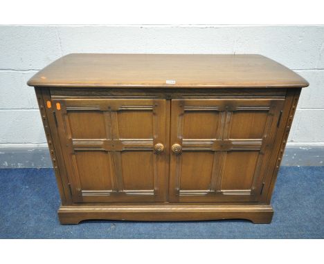 AN ERCOL GOLDEN DAWN TWO DOOR ENTERTAINMENT  CABINET, with a hinged top, and an adjustable central shelf, width 106cm x depth