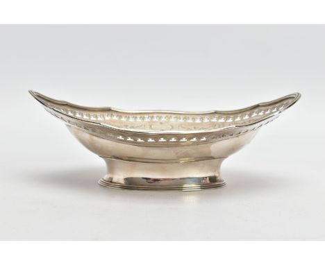 A VICTORIAN SILVER DISH, an oval dish detailing open work patterns, floral engraving and vacant cartouches, set upon a short 
