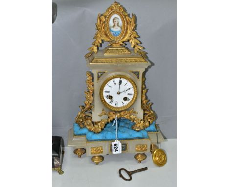 A LATE 19TH CENTURY ALABASTER AND GILT METAL MANTEL CLOCK, with foliate and oval surmount inset with an oval porcelain plaque