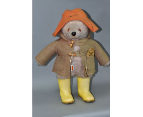 A GABRIELLE DESIGNS PADDINGTON BEAR, extensive fading and wear to duffle coat, hat and yellow Dunlop wellington boots but sti