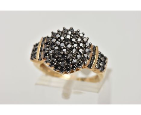 A 9CT GOLD BLACK DIAMOND CLUSTER RING, of a circular design, set with round brilliant cut black diamonds, black diamond detai