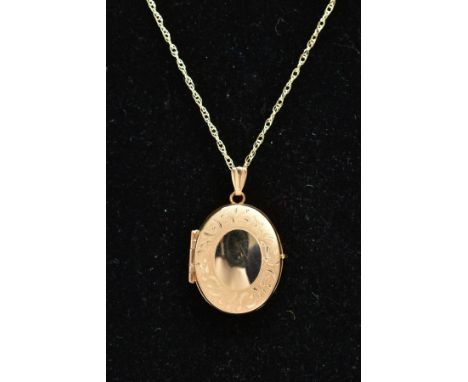 A 9CT GOLD LOCKET AND CHAIN, the locket of an oval form, stain finish with a vacant cartouche to the front centre, opens to r
