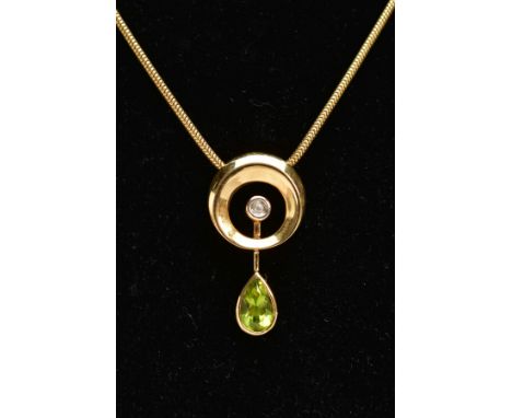 AN 18CT GOLD PERIDOT AND DIAMOND PENDANT AND CHAIN, the open circular pendant with vertical pivoting bar collet set with a pe