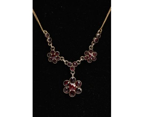 A BOHEMIAN GARNET PENDANT NECKLACE, three flower shaped clusters set with garnets within white metal mounts, stamped '835', f