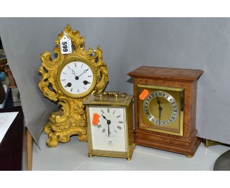 A LATE 19TH CENTURY GILT METAL MANTEL CLOCK AND TWO QUARTZ MOVEMENT CLOCKS, the gilt metal clock of Rococo form, enamel dial 