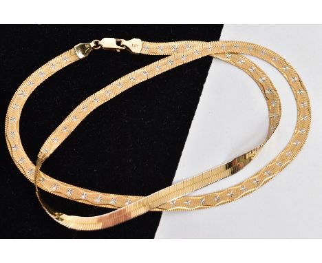 A BI-COLOUR HERRING BONE NECKLACE, a yellow metal herring bone necklace with a wave pattern and white metal star detailing on