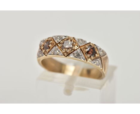 A 9CT GOLD DIAMOND DRESS RING, of a half eternity design, set with three brown round brilliant cut diamonds, and single cut d