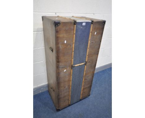 AN UPRIGHT COCKTAIL TRUNK, the exterior decorated with a vertical strip of beaten aluminium, wooden banding and leather corne