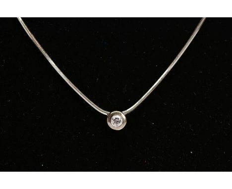 A DIAMOND PENDANT NECKLACE, the pendant of a circular design, set with a round brilliant cut diamond, bezel set, estimated to