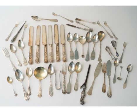 A group of mostly American Sterling flatware, comprising; two pairs of sugar tongs, two butter knives, three various forks, a