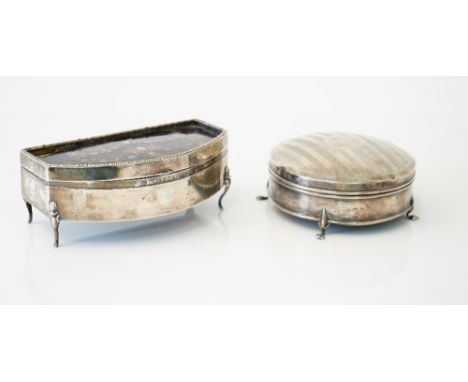 A silver hinge lidded circular trinket box, the domed lid decorated with engine turned bands, raised on four paw feet, Birmin