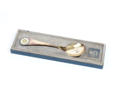 A Georg Jensen silver gilt and yellow enamelled spoon, detailed 1973, the handle having a yellow flowerhead finial,  import m