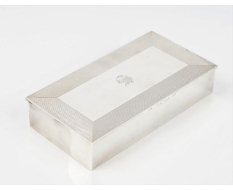 A silver table cigarette box, of rectangular form, the lid decorated with engine turned wide borders, wooden lined within, 20