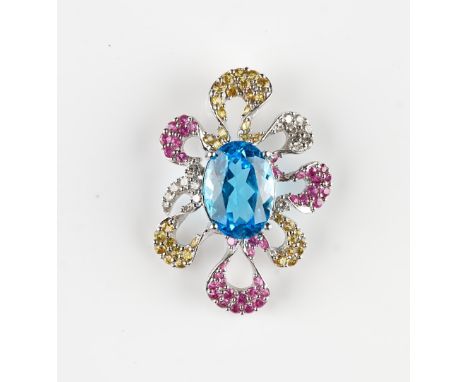 An 18ct white gold, blue topaz, diamond, ruby and yellow sapphire set pendant, in an oval abstract design, detailed 750, gros