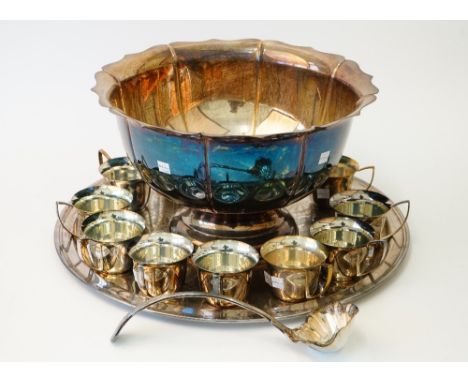 A silver plated punch bowl, having a shaped rim and panelled sides, a King's pattern punch ladle, a circular tray with foliat