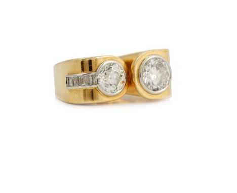 A Robert Kunz gold and diamond cocktail style ring, collet set with two graduated cushion shaped diamonds and with a curved r