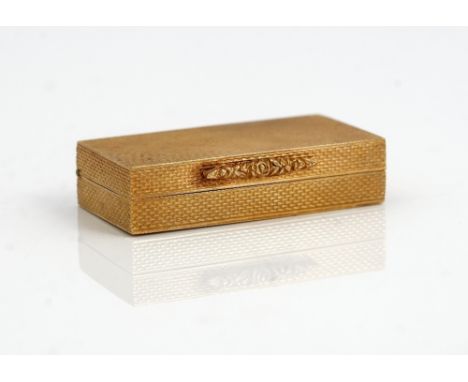 A 9ct gold rectangular hinge lidded pill box, retailed by Dunhill London, the exterior engine turned, initial engraved within