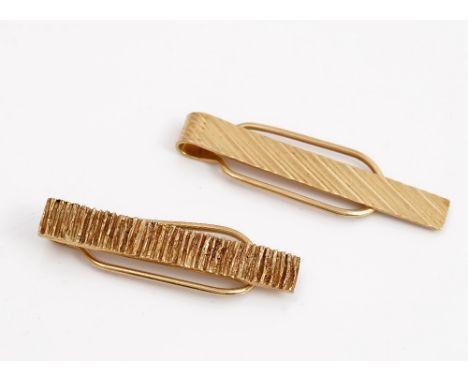 A Kutchinsky 9ct gold tie slide, with bark textured decoration, London 1970 and another Kutchinsky 9ct gold tie slide, decora