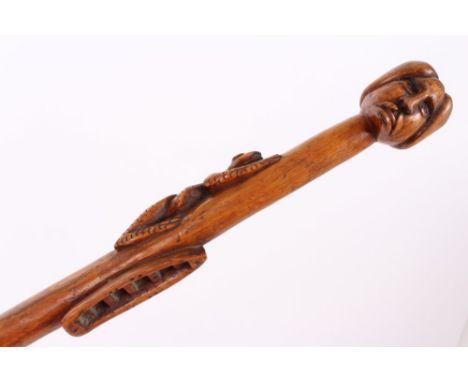 Highly unusual 19th century carved wood Colonial walking stick carved from the solid, with figurehead knop, the staff carved 