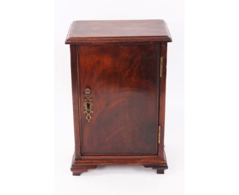 George III mahogany spice cupboard with moulded rectangular top and single door enclosing fitted interior of seven short draw
