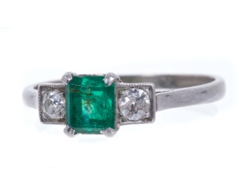 Art Deco emerald and diamond three stone ring with a central step cut emerald flanked by two old cut diamonds estimated to we