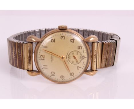 Early 1950s gentlemen's J. W. Benson gold wristwatch, the circular dial with applied gold Arabic numerals and subsidiary seco