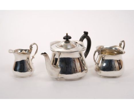 Edwardian silver Art Nouveau three piece tea set - comprising teapot of bulbous cauldron form, with ebony loop handle and spo