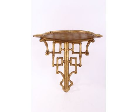 Early 19th century giltwood corner wall bracket in the Brighton Pavilion style, the shaped shelf on chinoiserie lattice suppo