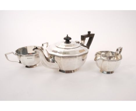 1920s silver three piece tea set - comprising teapot of cauldron form, with faceted decoration, on flared foot, domed hinged 