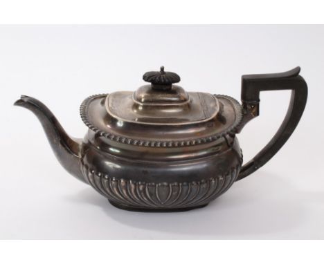 1920s silver teapot of cauldron form, with fluted decoration, engraved armorial and gadrooned border, domed hinged cover with