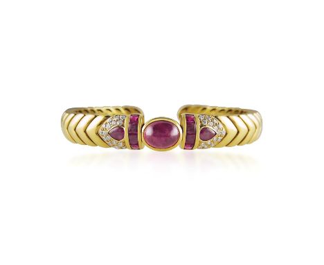 Cabochon ruby, diamond and 18ct gold sprung bangle by David Morris, the chevron pattern mount centring on an oval cabochon ru